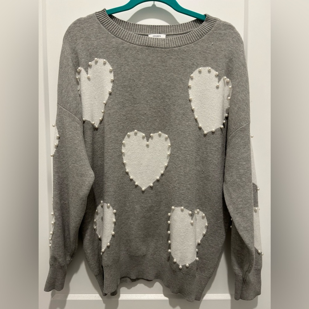 Women’s crown & ivy sweater with pearl heart embellishment.
